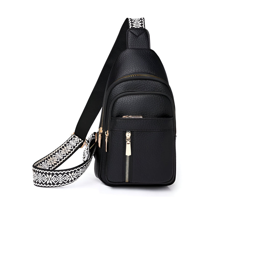 Sac à bandoulière noir en cuir avec fermeture éclair dorée et sangle à motif géométrique blanc et noir, idéal pour un style urbain et moderne.