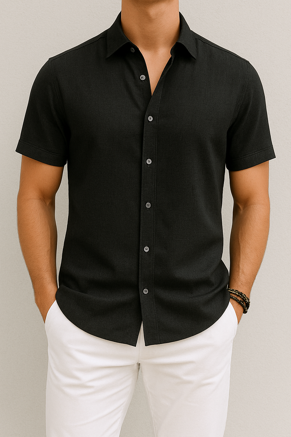 Chemise noire à manches courtes pour homme, élégante et moderne, portée avec un pantalon blanc. Mode masculine, style décontracté chic.