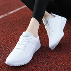Chaussures de course blanches sur piste rouge, design léger et respirant, idéales pour le sport et la course à pied, confort et style moderne.