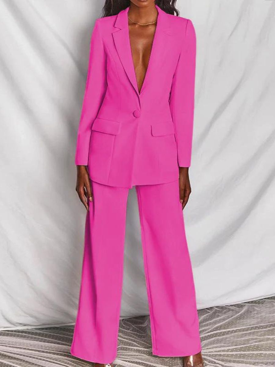 Costume femme rose vif, veste à un bouton, pantalon large, élégant et moderne, mode féminine, tenue professionnelle chic.