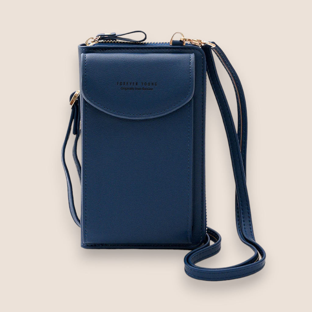 Sac bandoulière bleu marine en cuir synthétique, design moderne, avec rabat et bandoulière ajustable. Accessoire mode femme élégant et pratique.