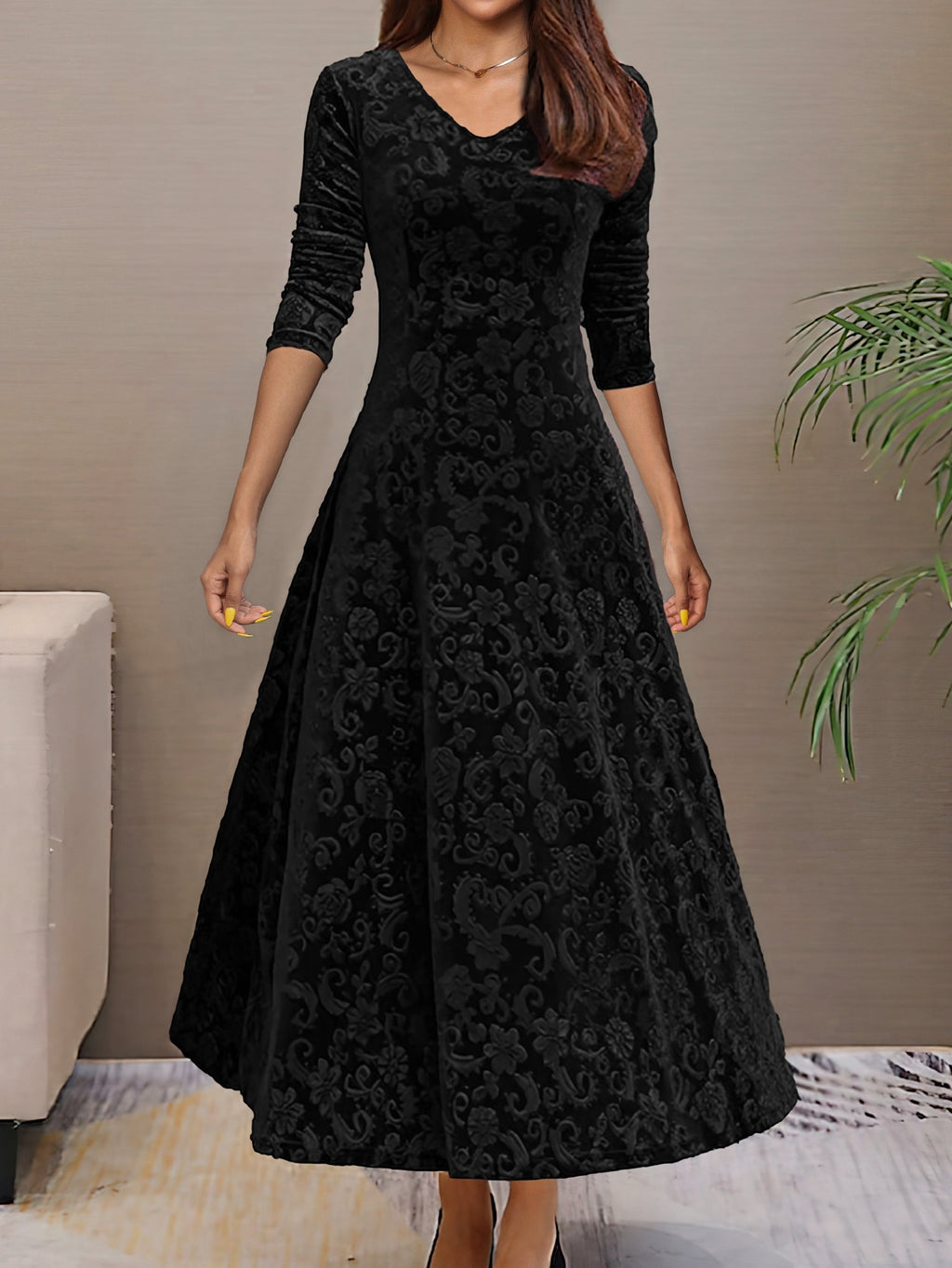 Robe longue noire en velours avec motifs floraux, manches trois-quarts, col en V, élégante et chic, idéale pour soirées ou événements formels.