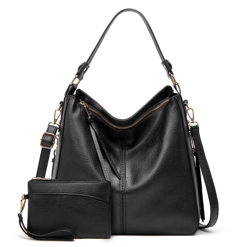 Sac à main en cuir noir élégant avec bandoulière amovible et pochette assortie. Design moderne, idéal pour la mode féminine et le quotidien.