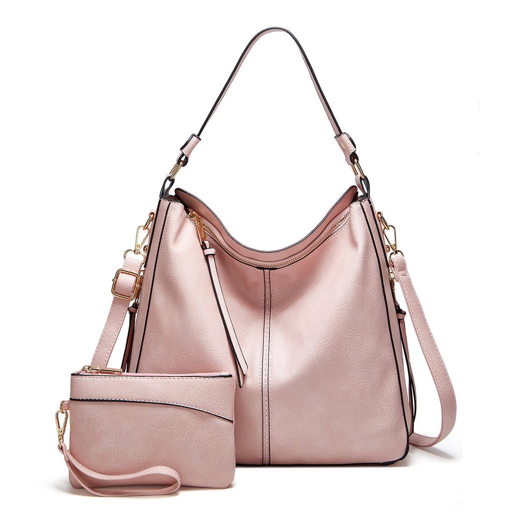 Sac à main rose en cuir avec pochette assortie, bandoulière amovible, design élégant et moderne, idéal pour femme, mode et accessoires tendance.