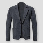 Veste blazer en laine grise pour homme, élégante et moderne, avec poches avant et bouton unique, idéale pour un look professionnel ou décontracté.