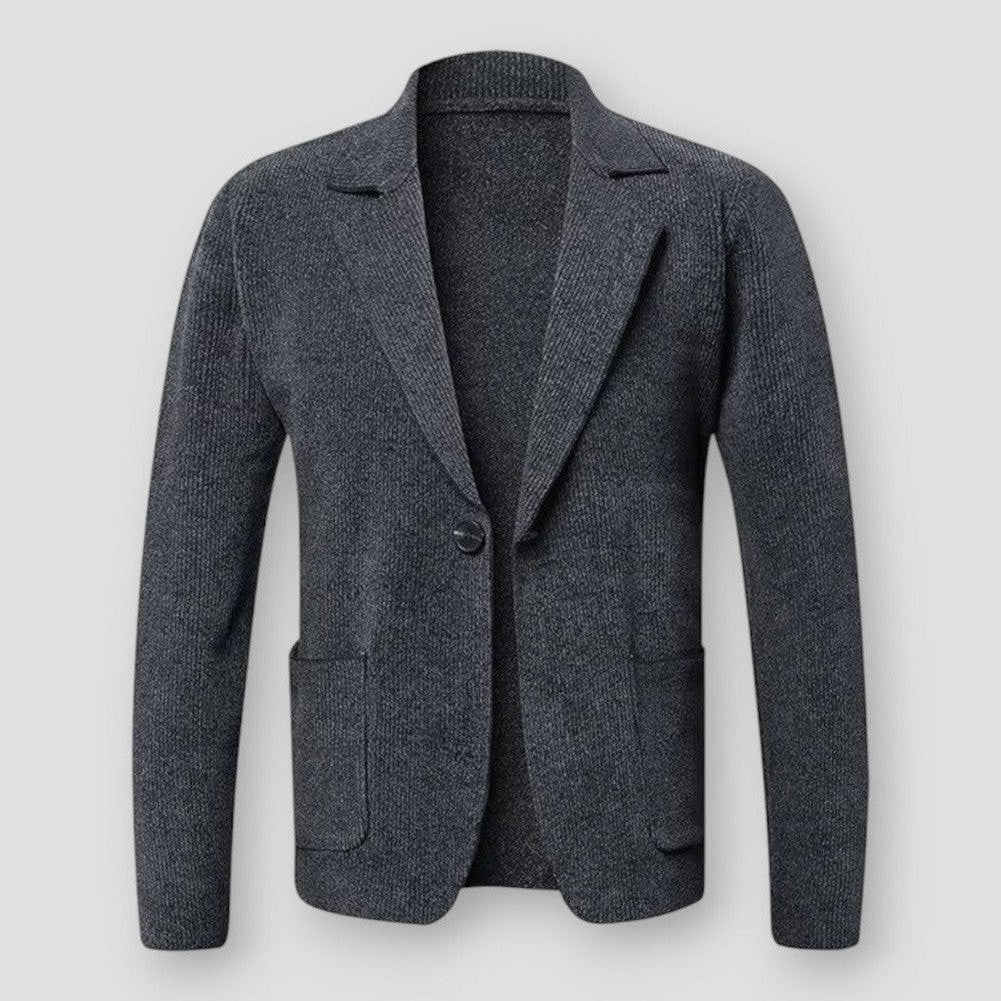 Veste blazer en laine grise pour homme, élégante et moderne, avec poches avant et bouton unique, idéale pour un look professionnel ou décontracté.