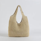 Sac cabas en paille tressée beige, design élégant et minimaliste, parfait pour l'été. Accessoire mode tendance, idéal pour la plage ou le shopping.