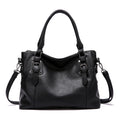 Sac à main en cuir noir élégant avec bandoulière amovible, boucles décoratives et poignées doubles. Accessoire mode femme chic et tendance.