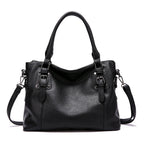 Sac à main en cuir noir élégant avec bandoulière amovible, boucles décoratives et poignées doubles. Accessoire mode femme chic et tendance.