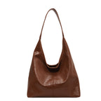 Sac à main en cuir marron, design minimaliste, bandoulière unique. Accessoire mode élégant pour femme, tendance et pratique.