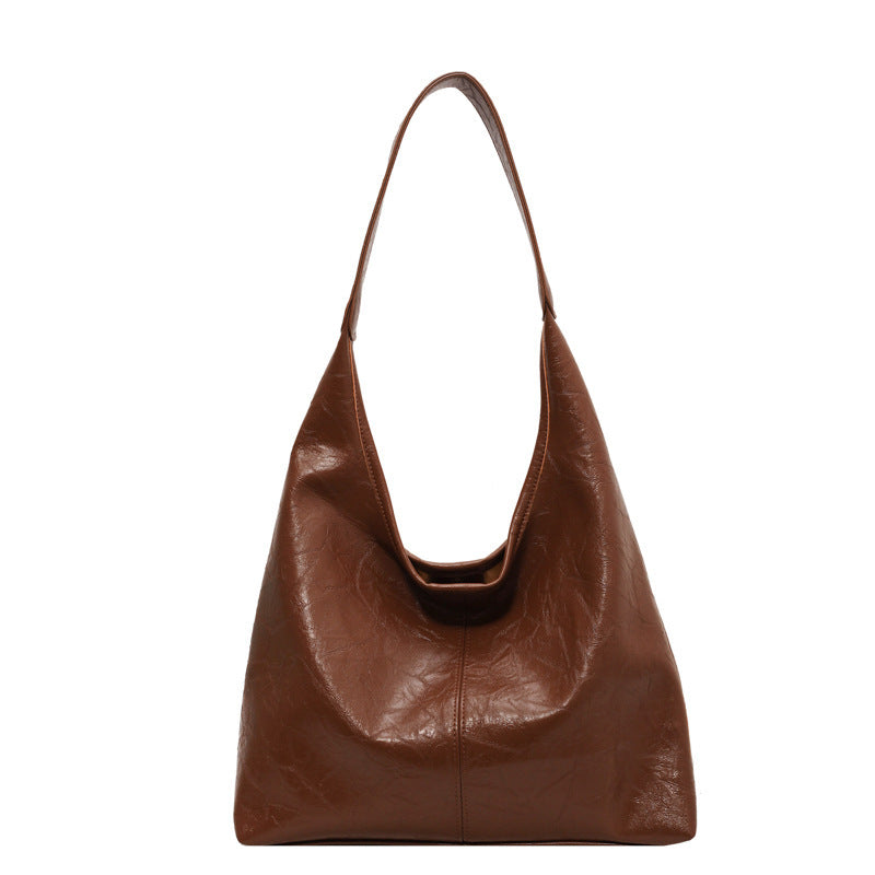 Sac à main en cuir marron, design minimaliste, bandoulière unique. Accessoire mode élégant pour femme, tendance et pratique.