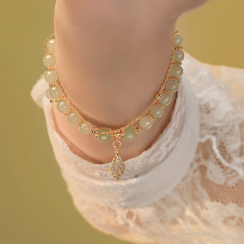 Chinese beaded bracelet with leaf pendant