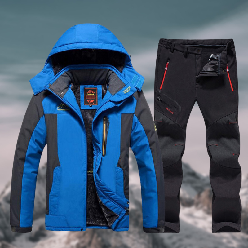 Veste de ski bleue et pantalon noir pour homme, imperméables et coupe-vent, idéals pour sports d'hiver en montagne.