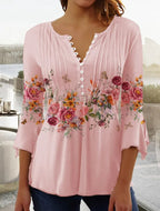 Blouse rose à manches longues avec boutons, ornée de motifs floraux colorés et papillons. Style décontracté, idéal pour la mode féminine printanière.