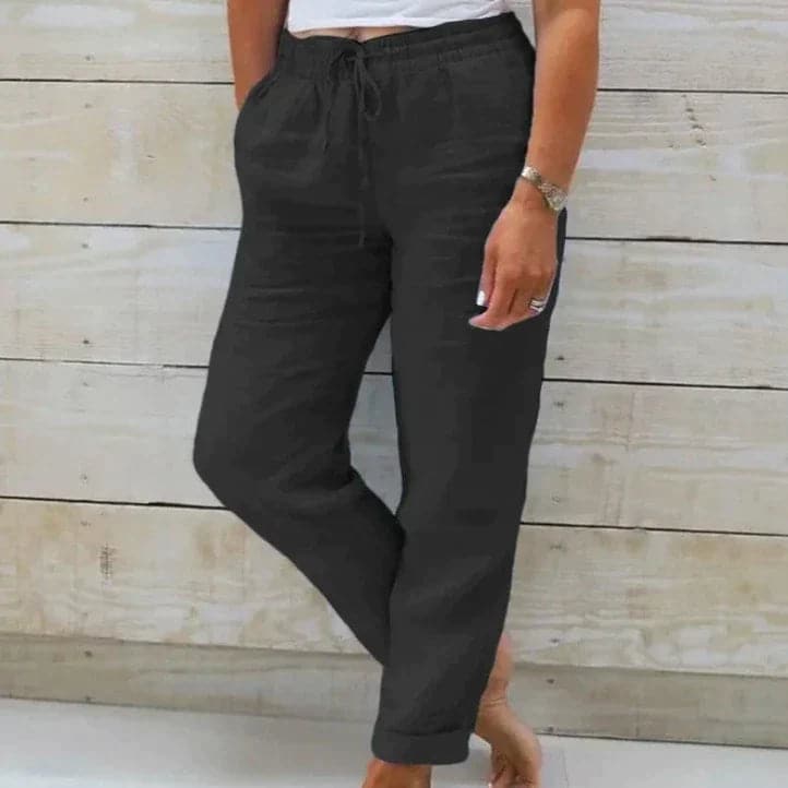 Pantalon noir décontracté pour femme, taille élastique, poches latérales, style confortable et moderne, idéal pour la mode quotidienne.