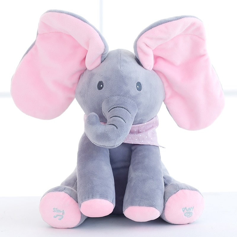 Peluche éléphant gris et rose avec grandes oreilles, écharpe à pois, assis sur fond blanc. Jouet doux pour enfants, cadeau mignon.