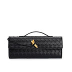 Sac à main en cuir noir tressé avec poignée, fermoir doré élégant. Accessoire de mode chic et tendance pour femme.