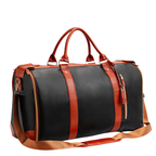 Sac de voyage en cuir noir et marron avec poignées robustes, bandoulière ajustable, fermetures éclair dorées. Élégant et pratique pour déplacements.