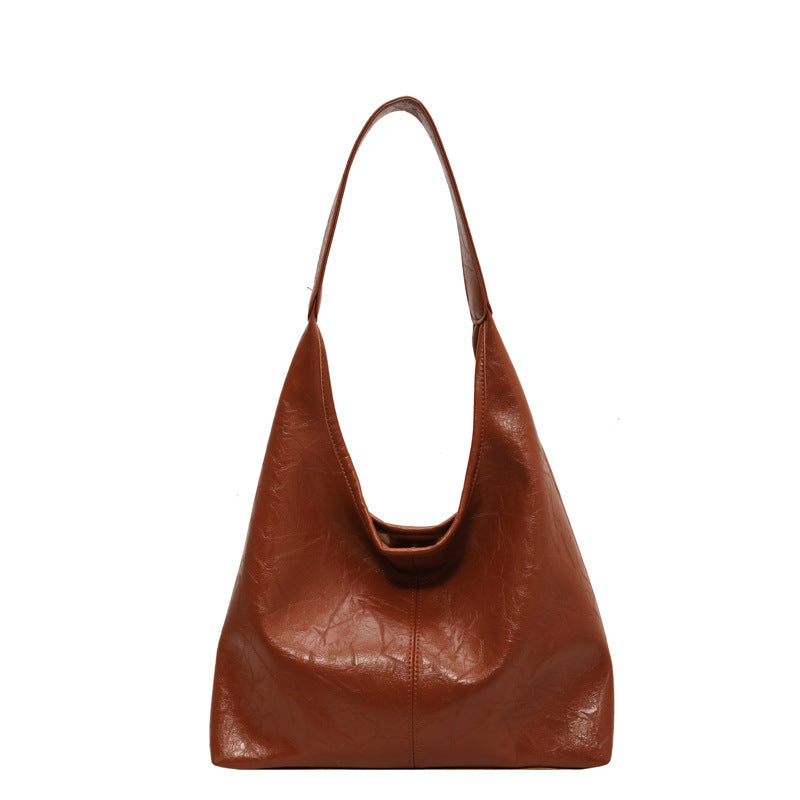 Sac à main en cuir marron, design minimaliste, bandoulière large, style élégant et moderne, accessoire de mode pour femme.