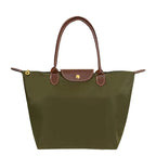 Sac à main en toile vert olive avec poignées et rabat en cuir marron, design élégant et pratique, idéal pour la mode féminine et le quotidien.