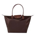 Sac à main en cuir marron, design élégant avec poignées doubles, idéal pour femme. Accessoire mode tendance, parfait pour toutes occasions.