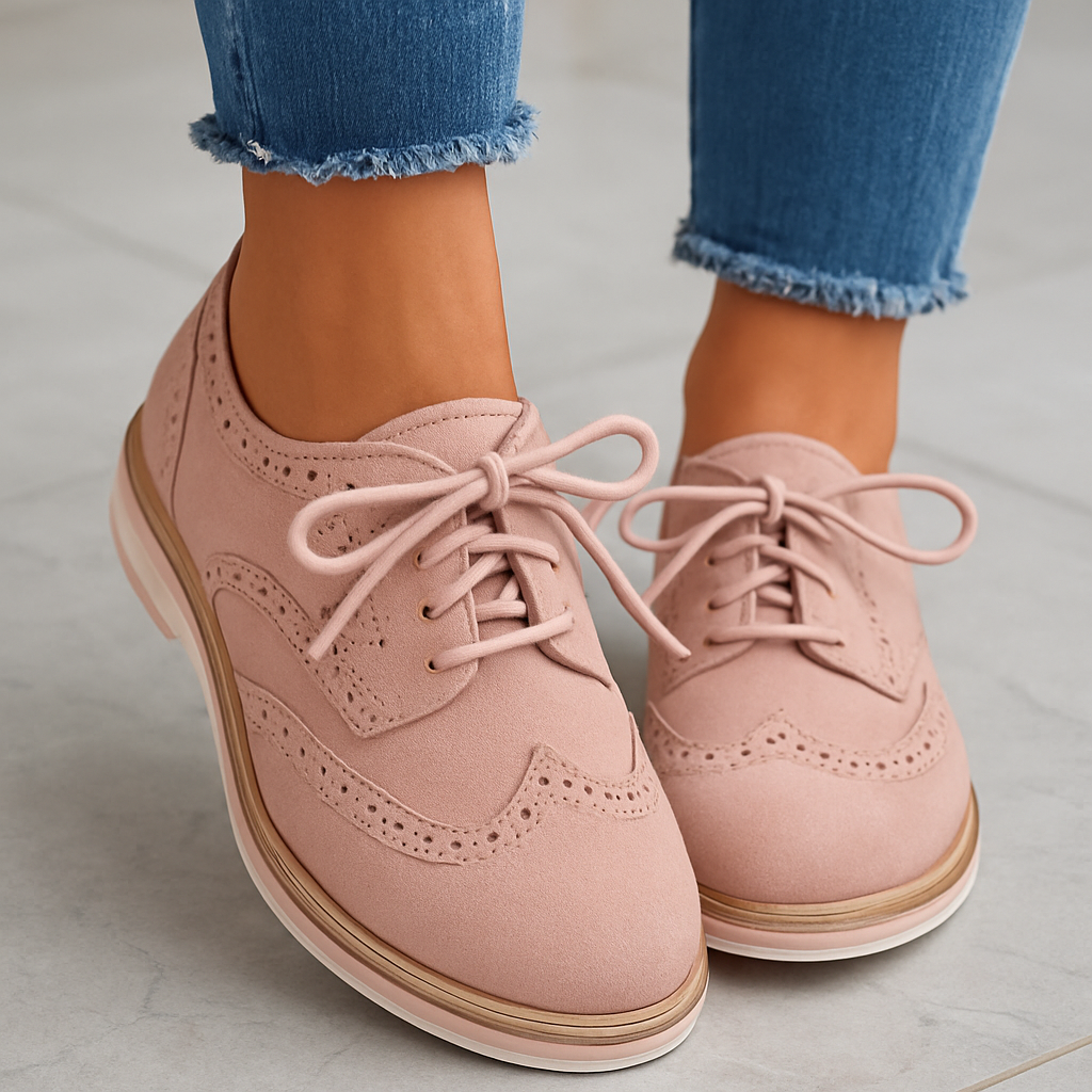 Chaussures derby roses en daim avec lacets, portées avec un jean bleu. Élégantes et modernes, idéales pour un look casual chic.