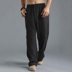 Pantalon ample noir pour homme, style décontracté, taille élastique, tissu léger, idéal pour l'été. Mode masculine confortable et tendance.
