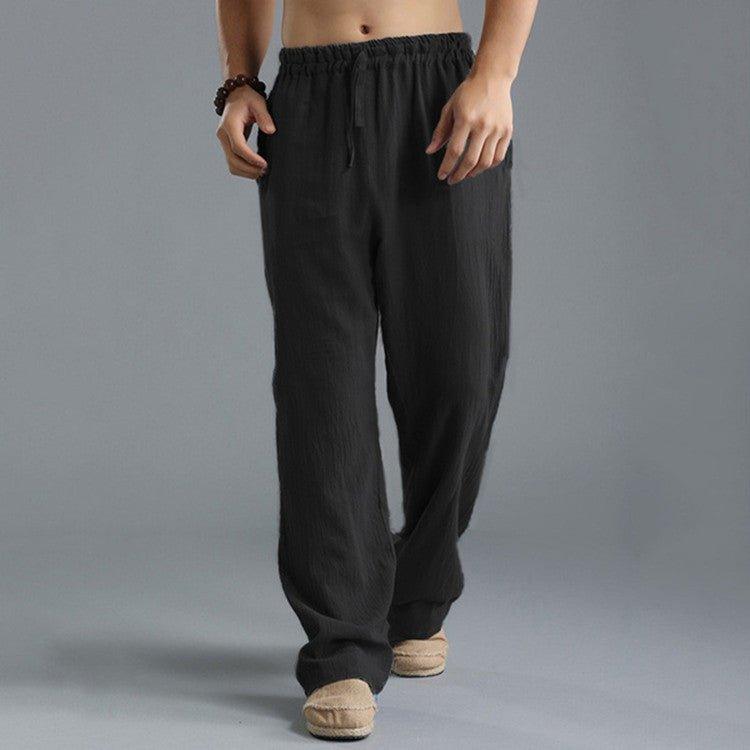 Pantalon ample noir pour homme, style décontracté, taille élastique, tissu léger, idéal pour l'été. Mode masculine confortable et tendance.