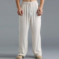 Pantalon ample en lin blanc pour homme, style décontracté, taille élastique, idéal pour l'été et les loisirs. Confort et élégance assurés.