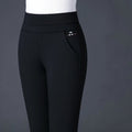 Pantalon noir femme élégant, taille haute, avec poches latérales, tissu extensible, mode automne-hiver, style chic et confortable.