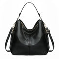 Sac à main noir en cuir élégant avec bandoulière réglable, fermeture éclair dorée et design moderne. Accessoire mode femme chic et pratique.