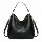 Sac à main noir en cuir élégant avec bandoulière réglable, fermeture éclair dorée et design moderne. Accessoire mode femme chic et pratique.