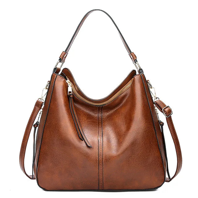 Sac à main en cuir marron élégant avec bandoulière amovible, design moderne et spacieux, idéal pour la mode féminine et le quotidien.