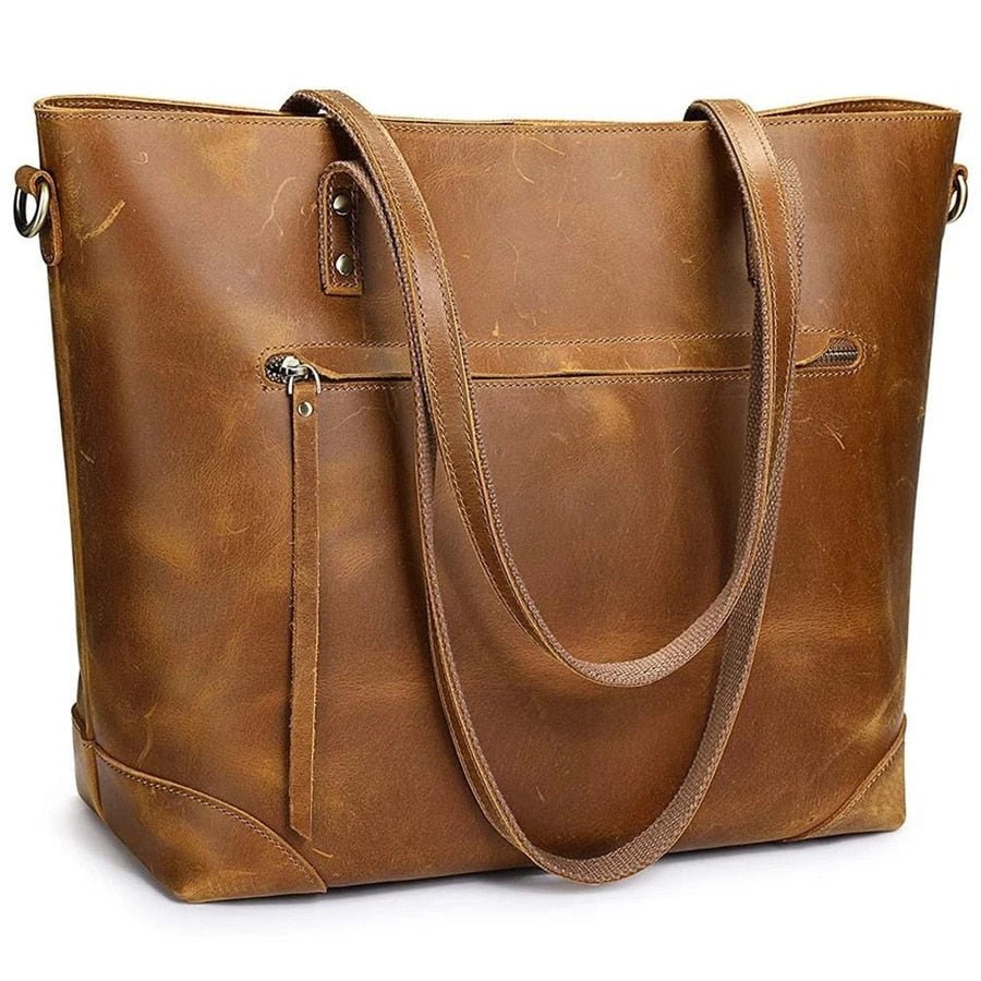 Sac à main en cuir marron vintage, design élégant avec poches zippées, anses robustes. Accessoire mode femme, tendance et pratique.