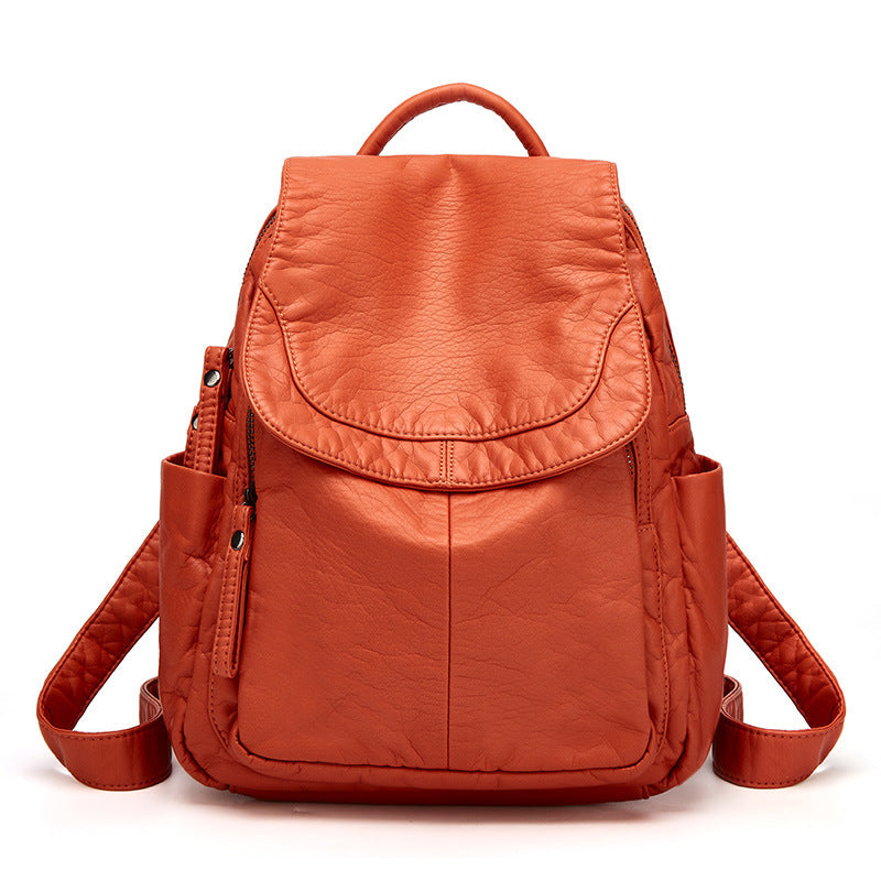 Sac à dos en cuir orange, design moderne, poches latérales, fermeture éclair, idéal pour voyage, école, mode femme, accessoires pratiques.