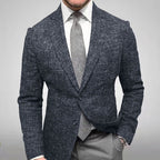 Homme en costume gris élégant, veste texturée, cravate assortie, chemise blanche. Mode masculine, tenue professionnelle, style classique.