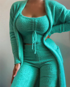 Femme en ensemble loungewear vert menthe, composé d'un cardigan, d'un top court et d'un pantalon taille haute, en tissu texturé doux.