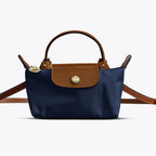 Sac à main en cuir bleu et marron, design élégant, bandoulière ajustable, idéal pour mode féminine, accessoires tendance, style chic et moderne.
