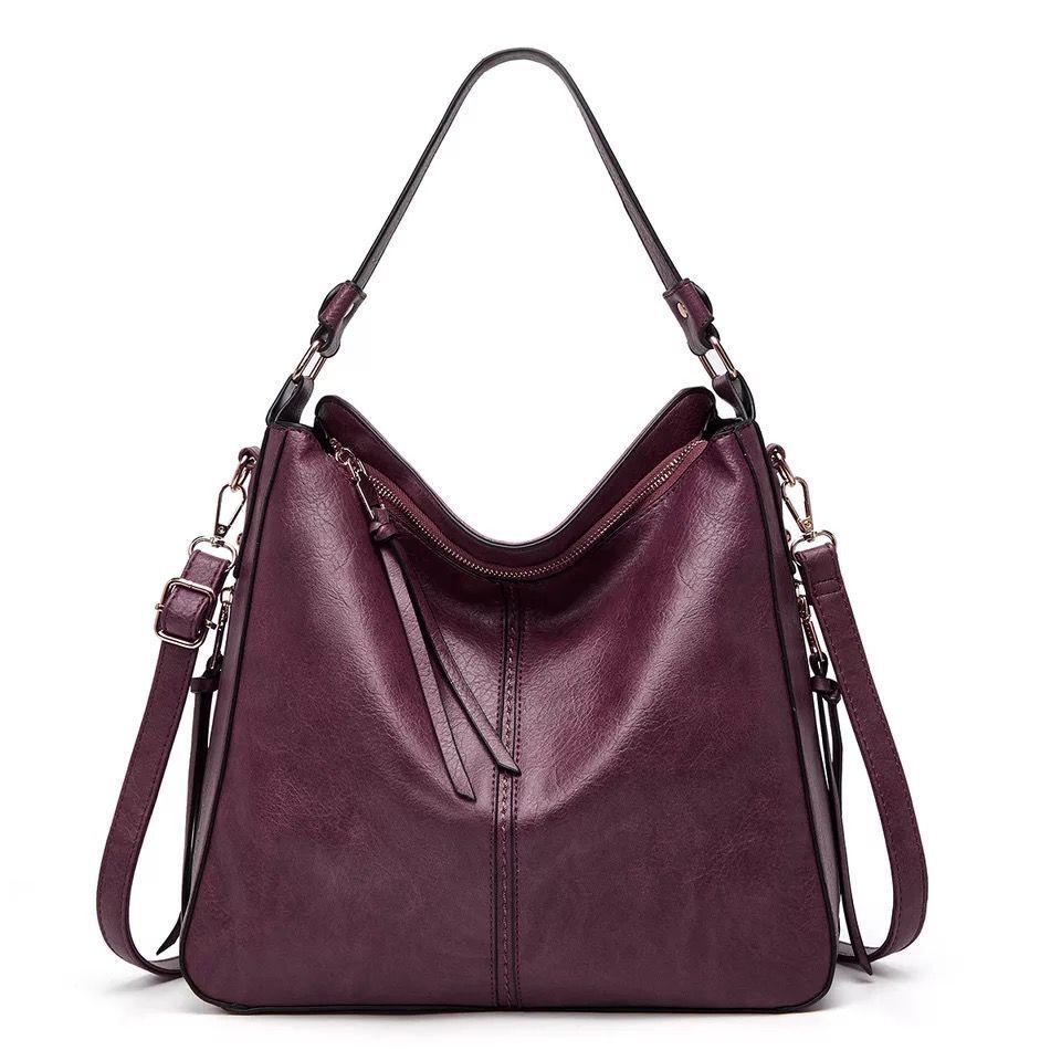 Sac à main en cuir bordeaux pour femme avec bandoulière réglable, design élégant et moderne, idéal pour la mode et le quotidien.