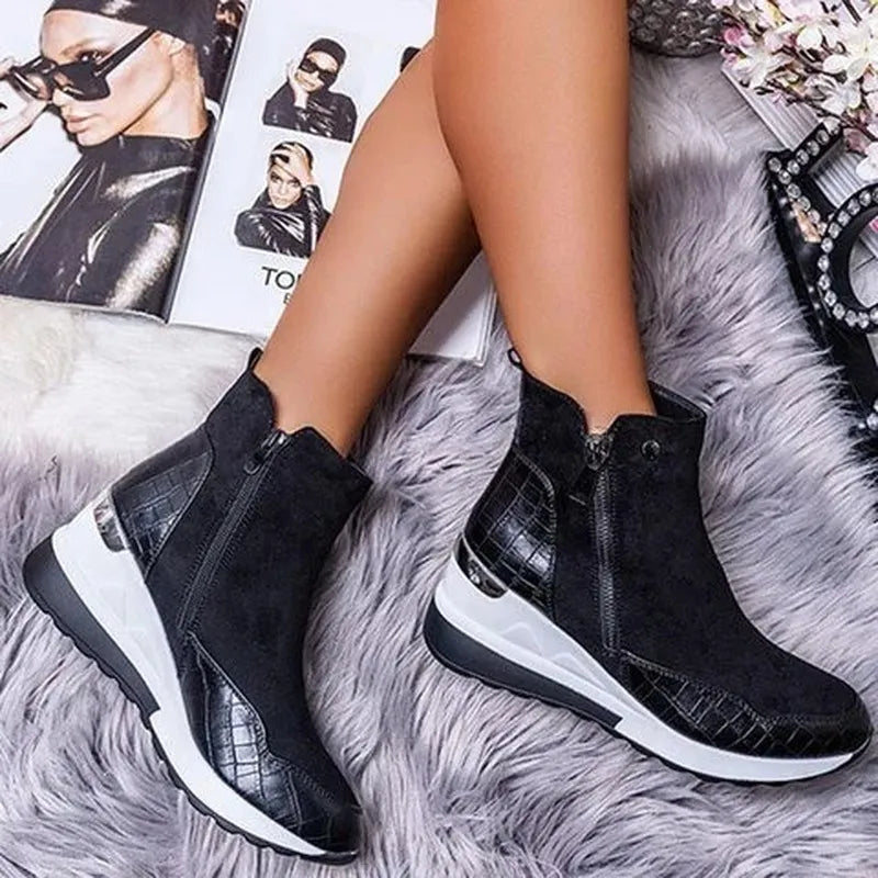 Bottes noires en cuir avec semelles blanches sur tapis gris, jambes croisées, magazines de mode en arrière-plan, style moderne et élégant.