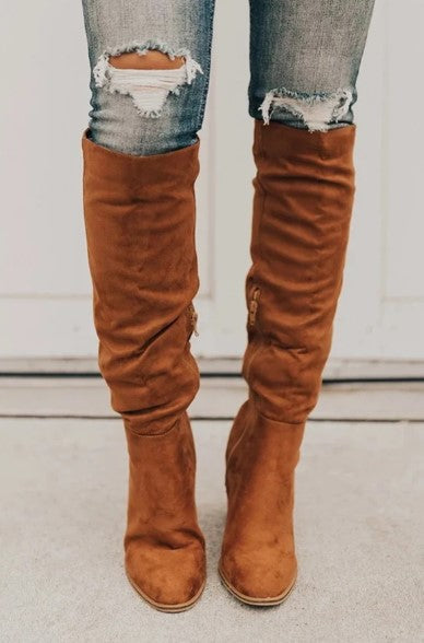 Bottes hautes en daim marron, style décontracté, portées avec un jean déchiré. Mode automne, tendance chaussures femme.