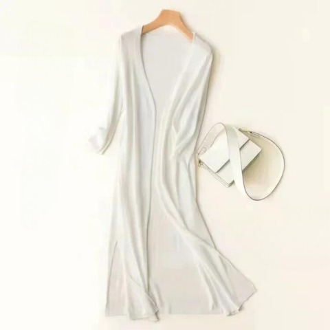 Robe longue blanche élégante sur cintre, accompagnée d'un sac à main blanc minimaliste. Mode féminine chic, style épuré et moderne.