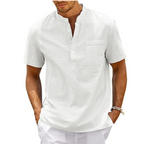 Homme portant une chemise blanche en lin à manches courtes, col mao, avec poche poitrine. Mode estivale décontractée pour hommes.