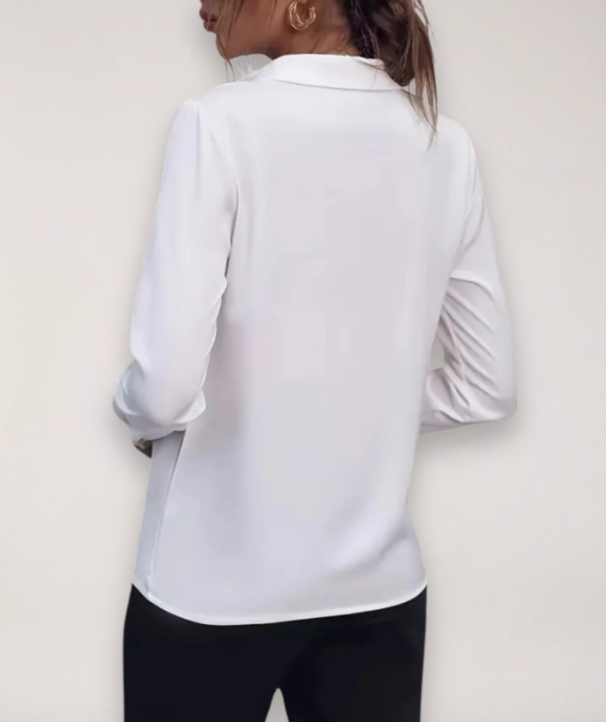 Women's tailored blouse with button placket, ideal for office wear.