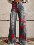 Pantalon large à motifs géométriques noirs et blancs avec des accents rouges, style moderne et tendance, idéal pour la mode automne-hiver.