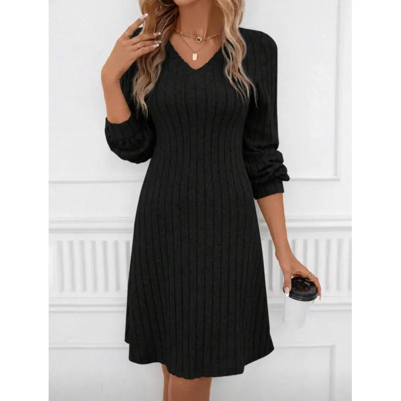 Robe pull noire à manches longues, col en V, tenue élégante pour femme, accessoirisée de colliers dorés, tenue automne-hiver, mode féminine.