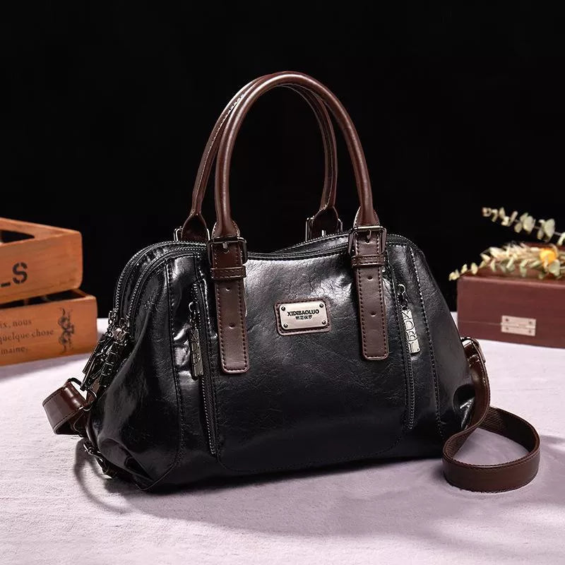Sac à main en cuir noir élégant avec poignées marron, design moderne, idéal pour femmes. Accessoire mode tendance, parfait pour toutes occasions.