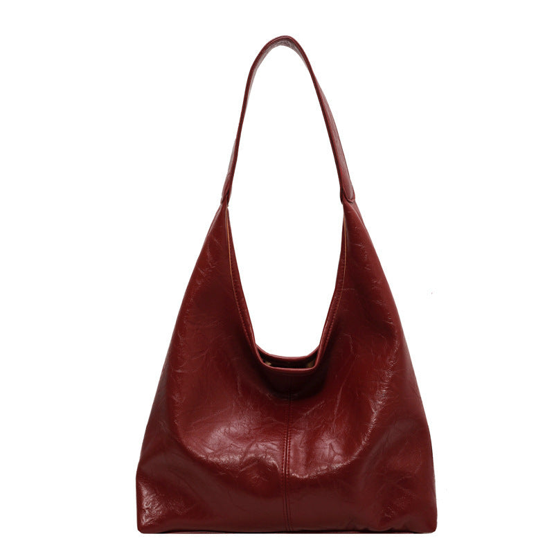 Sac à main en cuir rouge élégant, design moderne, anse unique, idéal pour la mode féminine. Accessoire tendance pour toutes occasions.