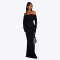Robe longue noire à paillettes, épaules dénudées, portée par une femme avec sac à main argenté. Mode élégante, tenue de soirée glamour.