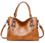 Sac à main en cuir marron élégant avec bandoulière amovible, boucles décoratives et design moderne. Accessoire mode femme chic et pratique.